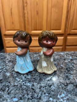 Vintage Brown Glaze Clay Hawaii Hula Girls Pair of Salt and Pepper Shakers.  Size approximately 3 1/2 inches tall.  Preowned.  The lightening is bad t