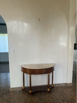 **Half-Moon Console Table**  Classic solid wood half-moon console table with elegant curved legs and brass accents. Perfect for an entryway, hallway, 