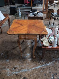This item is a vintage French Provincial style flip-top card/game table
