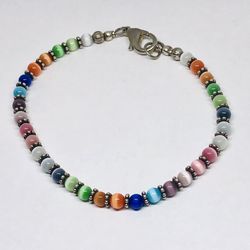 Silver tone bracelet with cats eye stone simulated glass beads