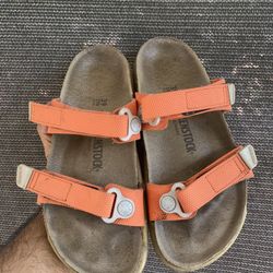 Birkenstock Atacama sandals in a bright orange colorway.