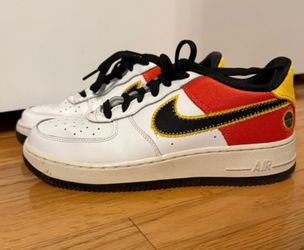 Nike Air Force 1 sneakers with red, black, and white panels and yellow stitching #airforce1 #basketball size 6Y used good condition