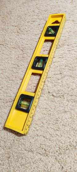 16" plastic spirit level with three vials and a built-in measurement scale.