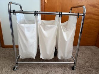 Metal framed laundry hamper on wheels
