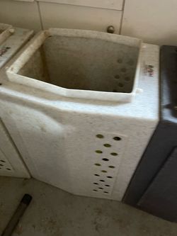 These items are heavy-duty, roto-molded heavy transport dog crates from RuffLand Performance Kennels. The images show two distinct finishes: the light