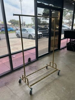 Gold Rolling Clothes Rack with Bottom Shelf
