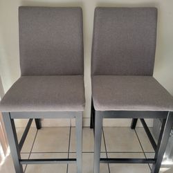 2 grey high dinning chairs