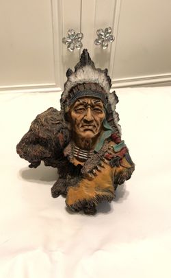 Indian/bull on tree trunk statue