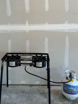 A gas stove and a full cylinder.
