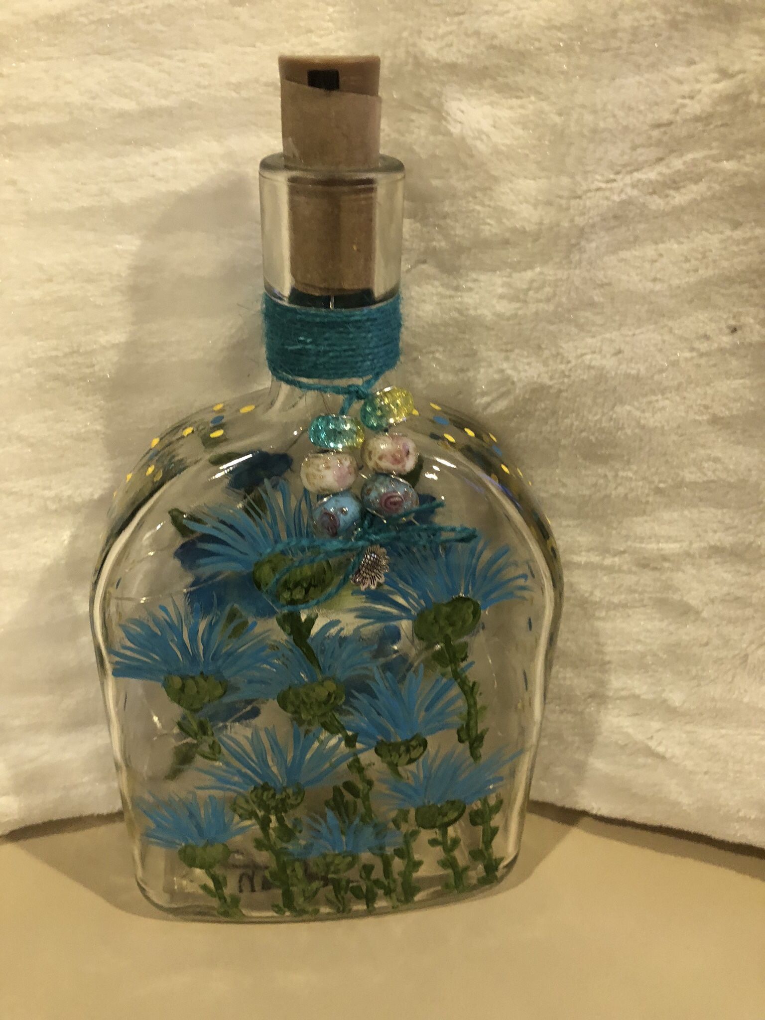 Blue Flowers Painted On Win Bottle.