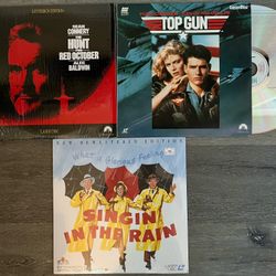 3 Laser Discs: Top Gun, Singing In The Rain,  & Hunt For Red October