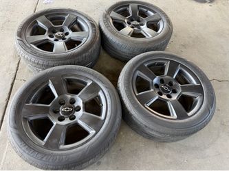20 inch stock oem Chevy rims and tires 5 spoke with Goodyear tires 6 lug
