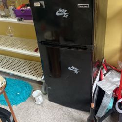 Refrigerator With A Couple Nike Stickers 