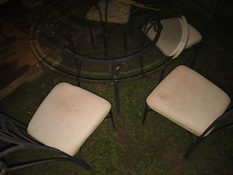Glass table with four chairs