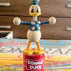 This is an extremely rare vintage figurine of Donald Duck, a beloved character from the Disney franchise. It is a highly sought-after collectible