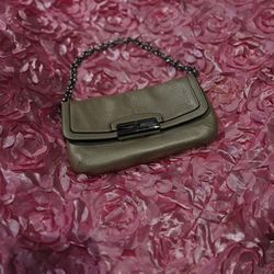 Light gold Coach bag, very pretty, you can use it with or without a strap