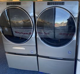 Grey Whirlpool Front Load Washing Machine and Electric Dryer Set on Pedestals (0-0112)