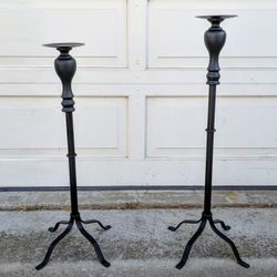 Pair of two black metal lightweight decorative uneven heigh portable tall candle holder floor stands