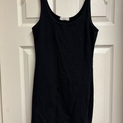 Sleek black mini dress. Sleeveless design. Perfect for any occasion. 🖤💋