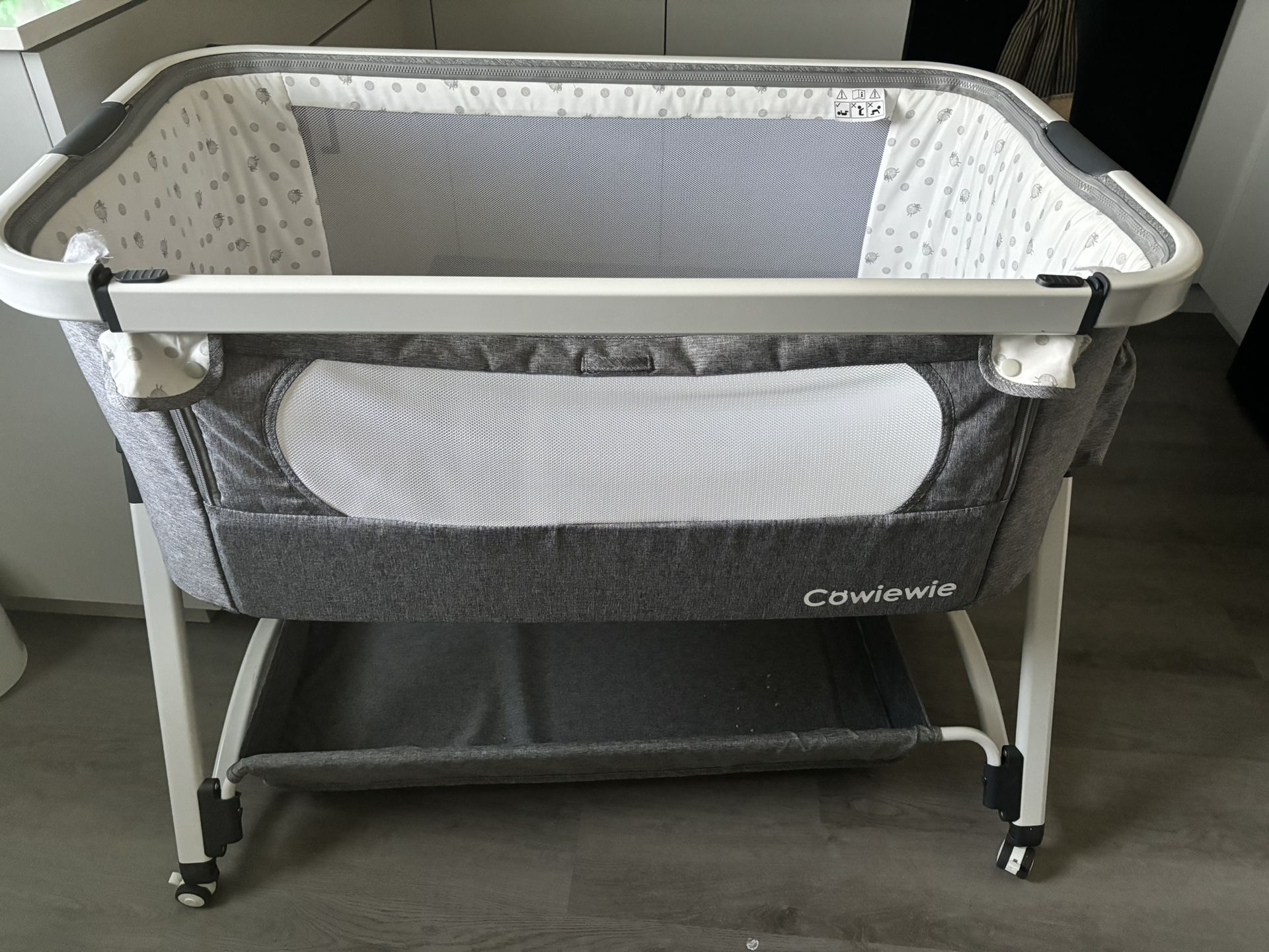 Bassinet, adjustable in height and tilting, can turn to cradle mode, removable bar next to bed, Under bassinet storage, used for a few months. 