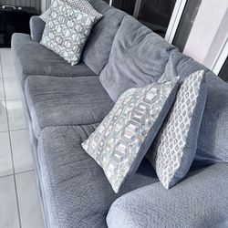 Light blue Sofa with pillows included and pull out bed