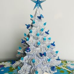 Vintage Ceramic Nowells Mold Light up Christmas tree. Beautiful Icy Powder blue glaze. 13” tall overall with tree sitting on the base. 