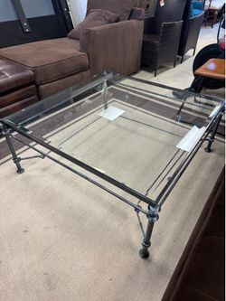 Giacometti-style coffee table features a patinated bronze-finished iron frame and a glass top - 40” x 40” x 17” - Excellent condition