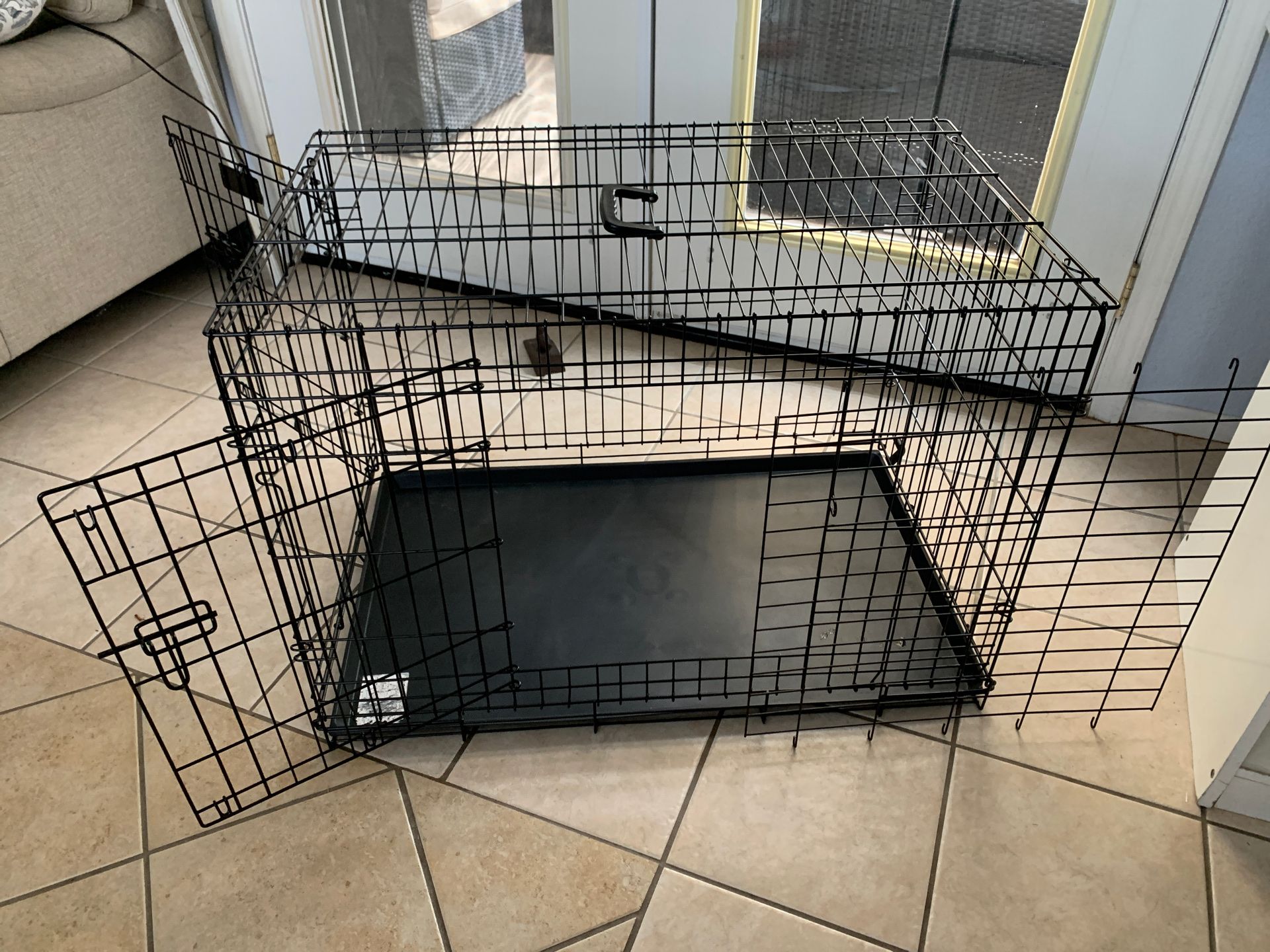 Large Dog Crate used for 1 month . 36 Inches Long 24 Wide And 25 High Has Divider If Needed