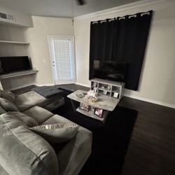 Gray sectional, Coffee Table, and TV Stand