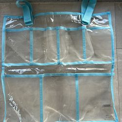 clear plastic multi-pocket hanging organizer with blue trim. 