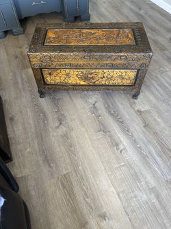 Antique Chinese carved camphor wood chest with floral and bird motifs.