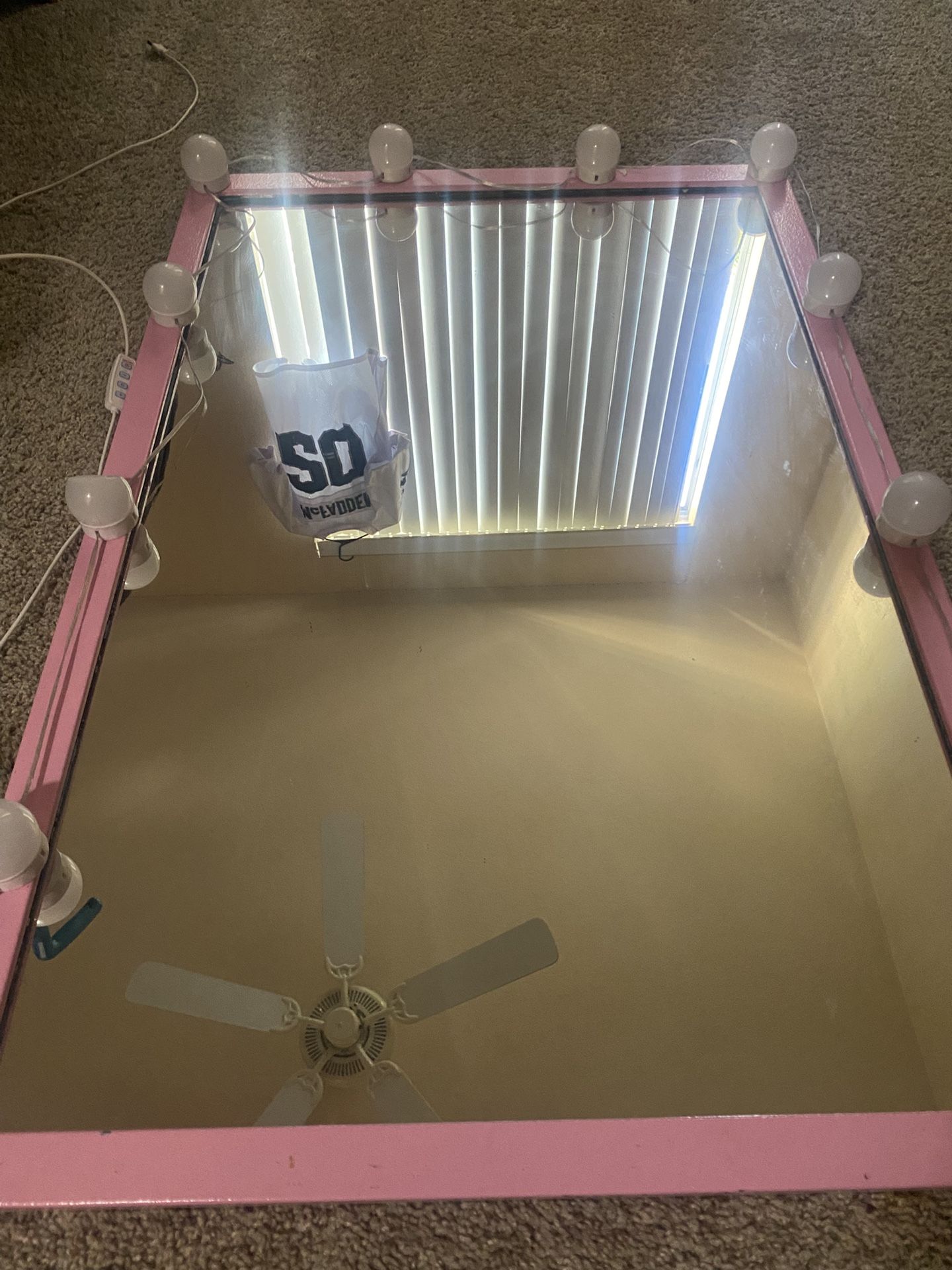 Pink mirror with lights