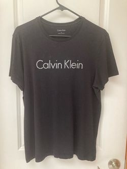 Black Calvin Klein crew neck tee with white logo print on the chest. Size medium.