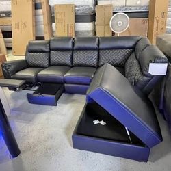 Reclining sectional couch with storage and cup holders. Delivery and financing available. 