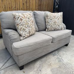 Brown Loveseat with Accent Pillows