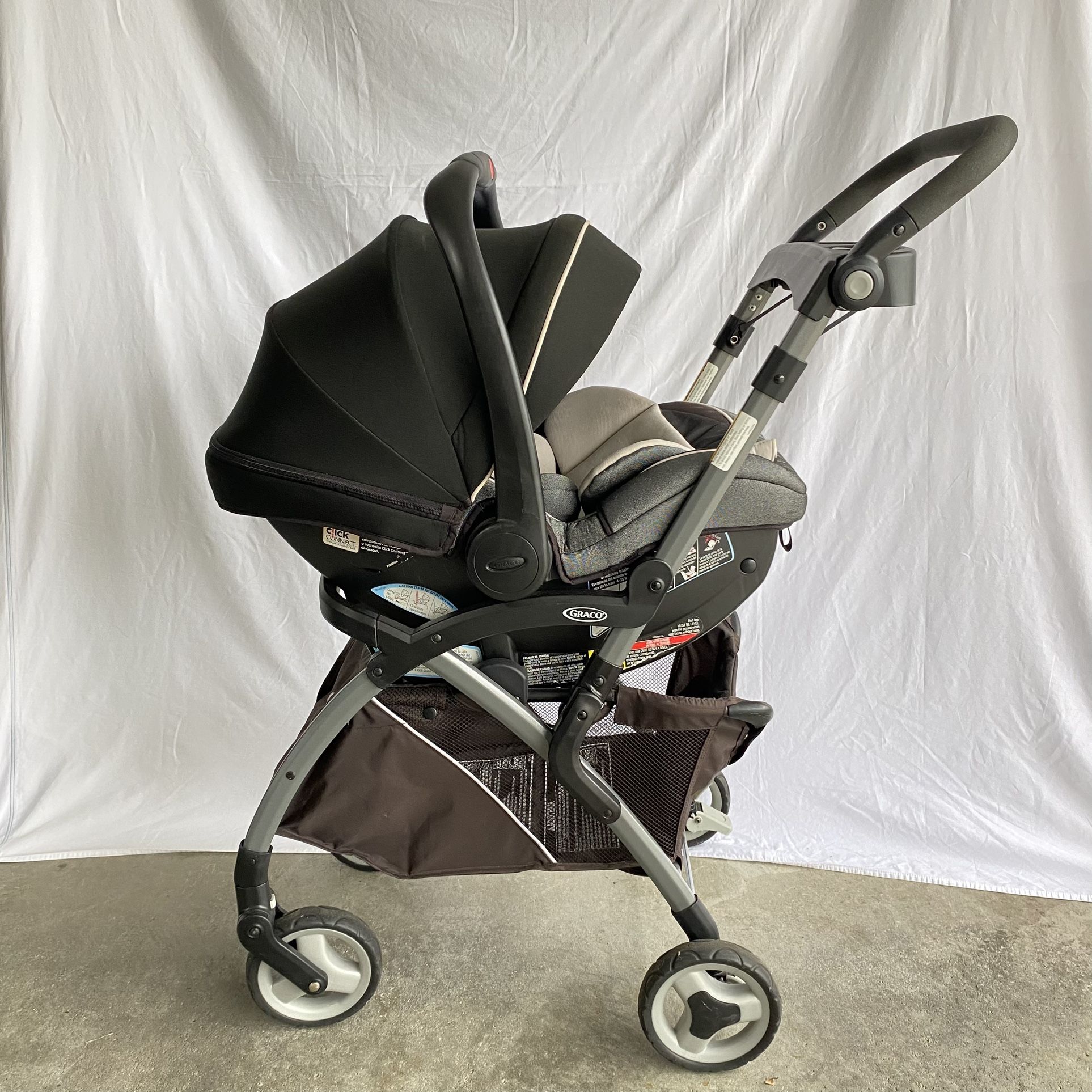 Graco SnugRider Elite car seat frame stroller with a Graco infant car seat attached