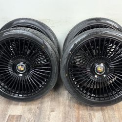 New 24 inch gloss black wheels with floating Cadillac caps wrapped in atturo az810 tires 285/40r24