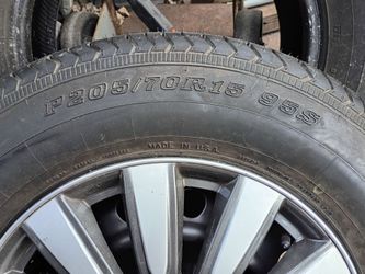 205/70/15 brand new tire with bud cap