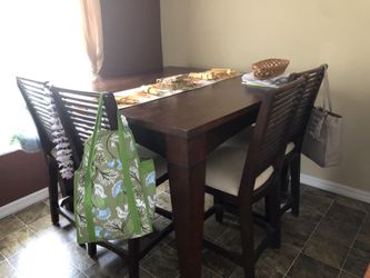 High table with four chairs and cabinet