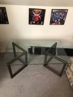 Glass top coffee table with metal legs.