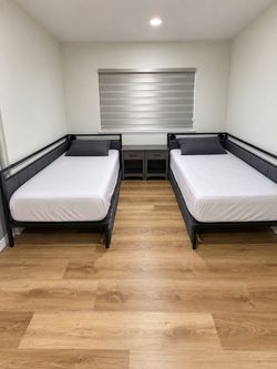 Twin XL beds with mattresses included.
