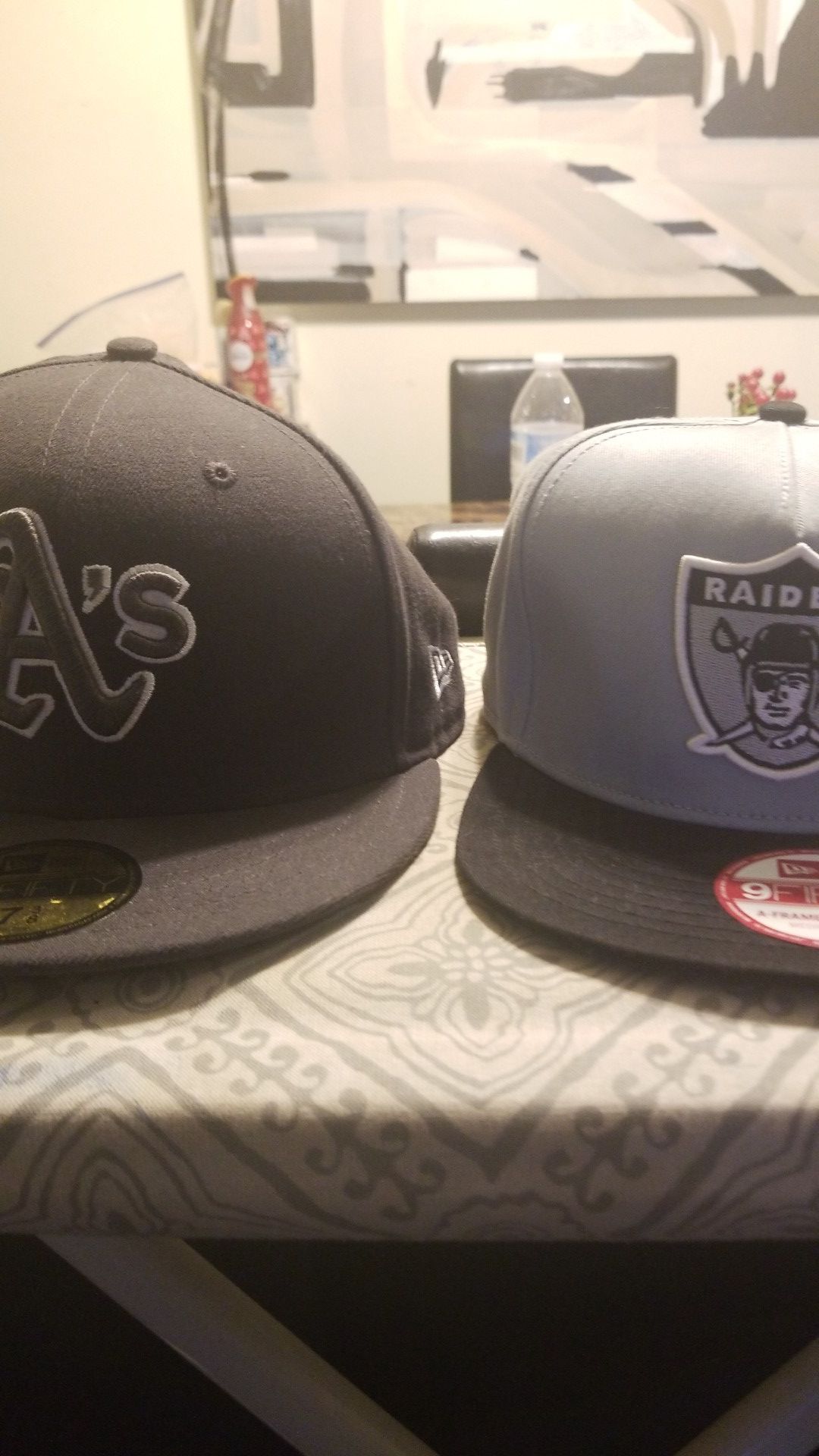 Oakland Athletics hat and Oakland Raiders hat
