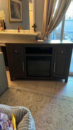 Gray cabinet with integrated light fireplace