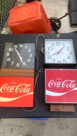 Two Coca-Cola clocks