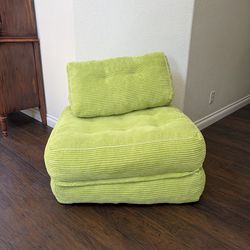 Chartreuse chair that converts to a bed.