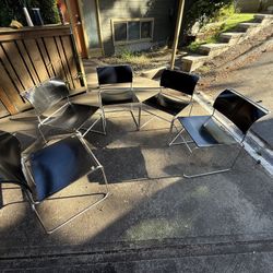 MCM Modern wood and metal stackable chairs. They are dusty but will clean up well. Top wood of chairs has imperfections. Spring cleaning and have not 