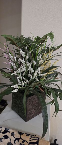 2 lanterns, 2 large brand-new candles, decorative piece, and a large artificial plant for sale.