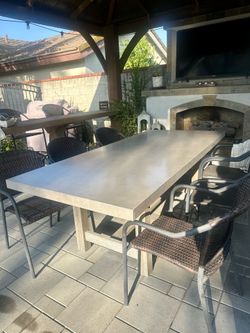 Crate and Barrel Gray Concrete Outdoor Table with six chairs