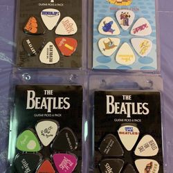 Brand new - 4 collectible Beatles guitar pick packs - great gift for a Beatles fan 