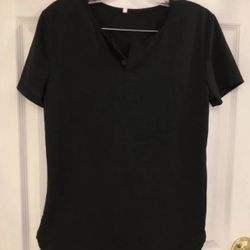 Size S Light weight black top with rounded sides and a slit up 